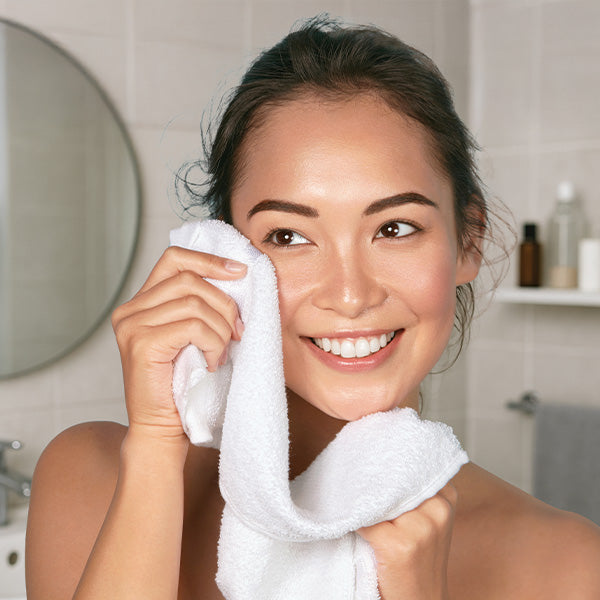 Woman enjoying soft towel on face