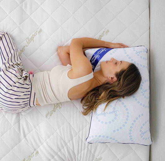 Young woman lying down on a cushiony mattress, with her spine in perfect alignment to help her sleep better.