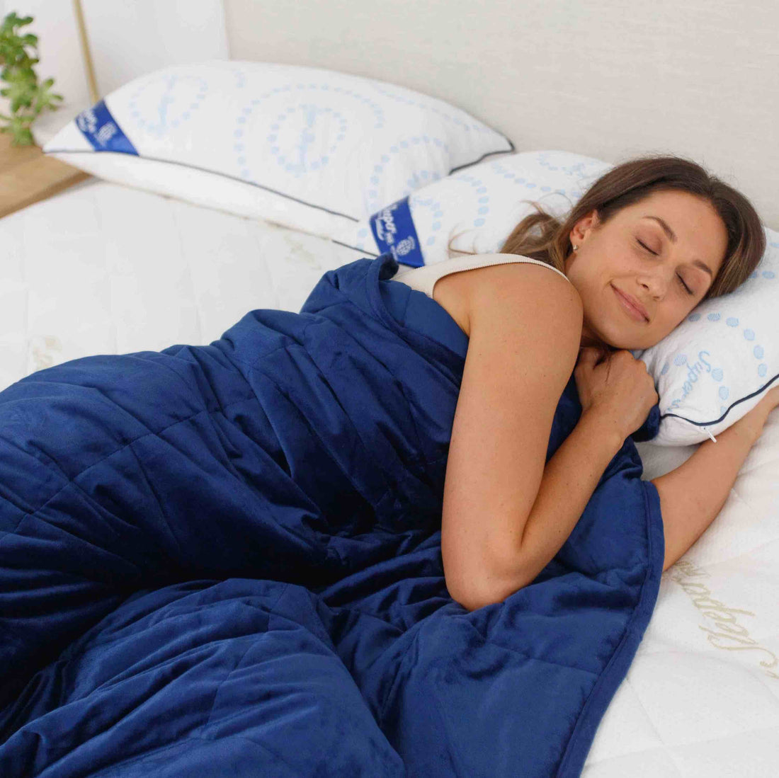 Super sleeper pro weighted blankets keeping a young woman warm while she sleeps.