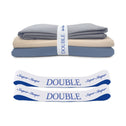 A set of neatly folded TEST broken variant os bed sheets by Super Sleeper Pro, in gray, beige, and blue, each with a white "DOUBLE" organiser band—ideal for sheet storage. Two extra labelled bands are also included.