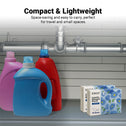 Four large blue and red bottles sit on a shelf under a sink, next to two small boxes of Kleva Range Stain Lifting Laundry Detergent Sheets. Above, text highlights these compact, lightweight, plastic-free laundry sheets. Plumbing pipes are visible above.