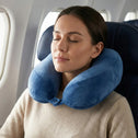 Woman resting on airplane wearing ergonomic memory foam travel neck pillow