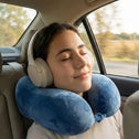 Passenger relaxing in car wearing soft supportive travel neck pillow