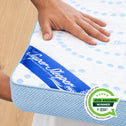 A hand presses down on the Straight 2 Sleep® Mattress Topper by Super Sleeper Pro, with the Super Sleeper Pro label visible. A 2026 Awards Winner badge from Product Review is displayed in the lower right corner. The topper showcases a white and blue polka dot design.