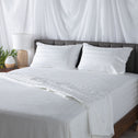 Freshly made bed with crisp white bedding