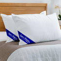 White pillows with blue logos on a bed