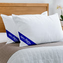 White pillows with blue logos on a bed