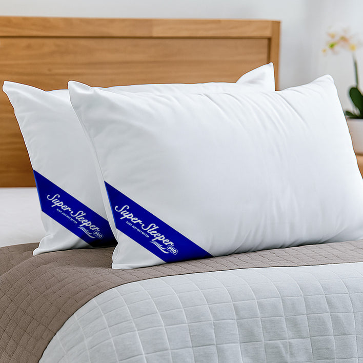 White pillows with blue logos on a bed