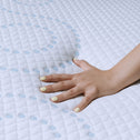 Hand touching a textured white surface with blue dots