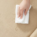 Water-resistant beige tatami floor mat being wiped clean, showing an easy-care tatami mat floor surface.