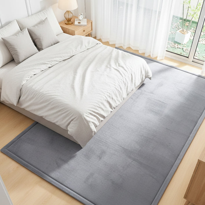 Large gray tatami floor mat placed under a bed, used as a sleeping tatami floor mat for added comfort.