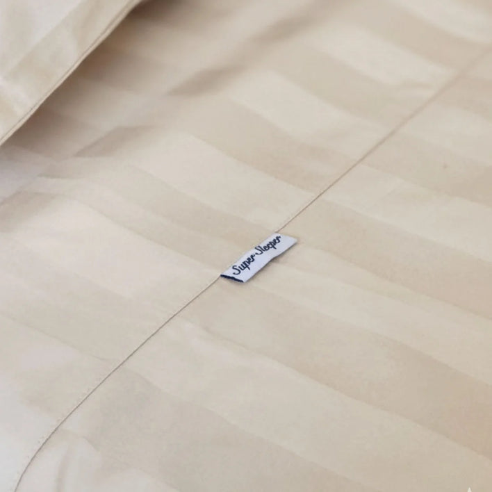 Close-up of a beige striped Royal Deluxe Imperial Dream Sheets™ Cotton Sateen 1200TC 4pc set by Super Sleeper Pro, featuring a small fabric tag and organiser bands—luxurious, silky-smooth bedding in a Buy 1 Get 1 FREE offer.