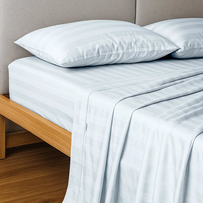 A neatly made bed features Super Sleeper Pro Buy 1 Get 1 FREE: Royal Deluxe Imperial Dream Sheets™ Cotton Sateen 1200TC 4pc Set in light gray stripes, with matching pillows, on a wooden frame and headboard, plus free organiser bands.