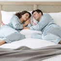 Couple sleeping comfortably on Marshmellow hotel pillows with soft, supportive fill for side sleepers