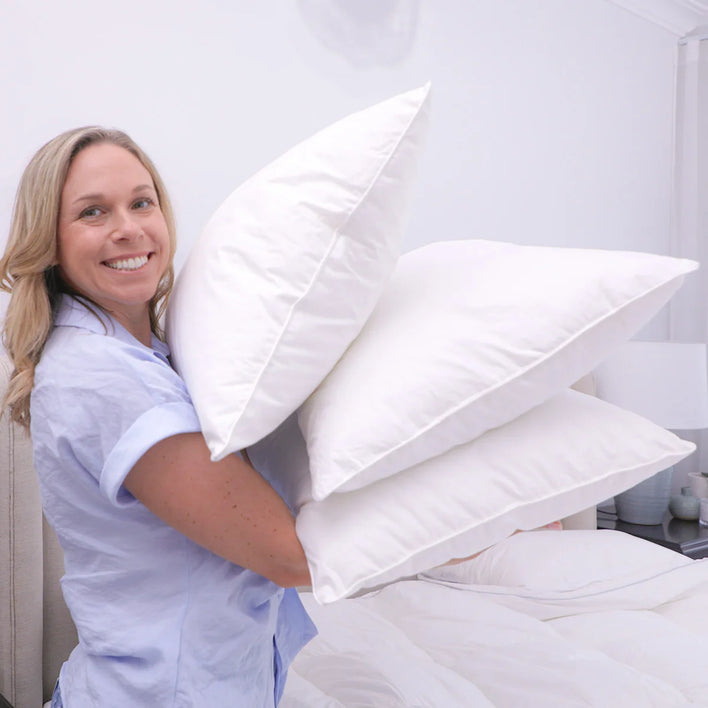 Marshmellow hotel pillows stacked on bed demonstrating volume, softness, and hotel-quality finish