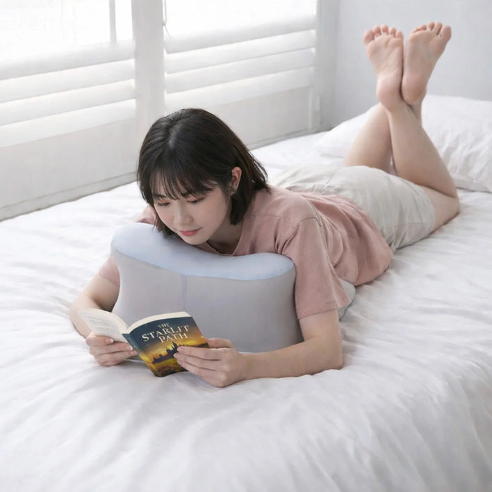 Ergonomic back support pillow used for reading while lying on bed