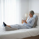 Adjustable back support pillow with leg elevation on bed