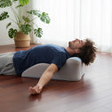 Back and neck support pillow used while lying face down on bed