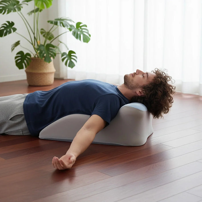 Back and neck support pillow used while lying face down on bed