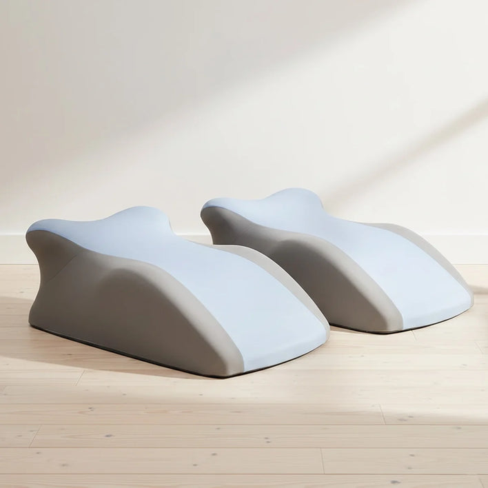 Ergonomic back support pillows placed on bed for posture support