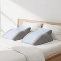 Ergonomic back support pillow placed on bed for side sleeping comfort