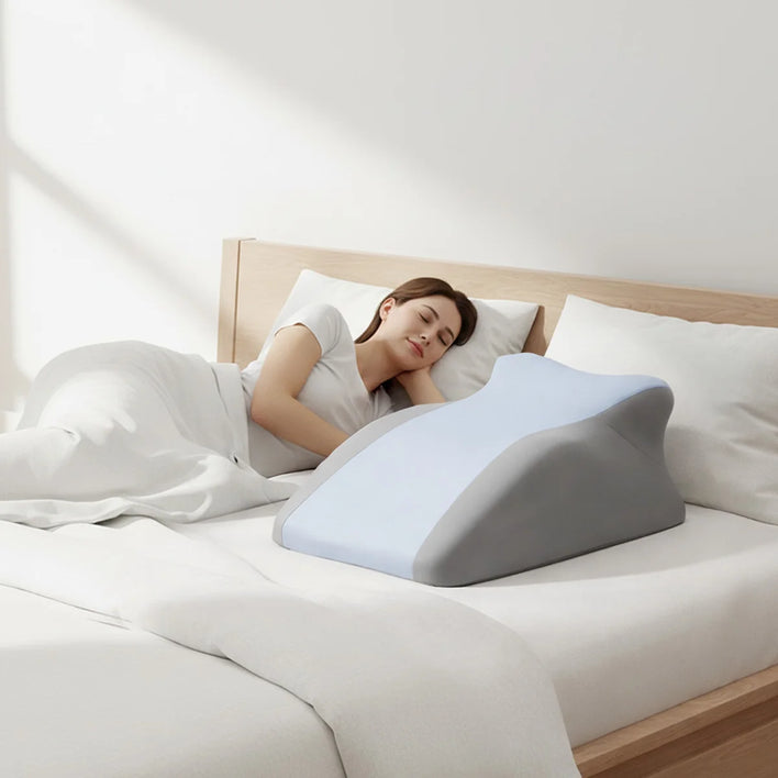 Ergonomic back support pillow placed on bed for side sleeping comfort