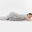 Side profile view of ergonomic back support pillow used while lying down