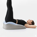 Leg elevation position using ergonomic back support pillow on floor