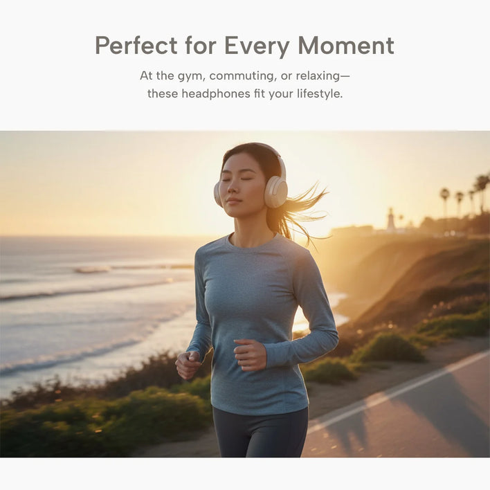 A woman jogs along a coastal path at sunset, focused and wearing Kleva® AudioUltra Noise Cancelling Wireless Bluetooth Headphones from the Kleva Range. She sports a long-sleeved athletic top amid ocean views and palm trees.