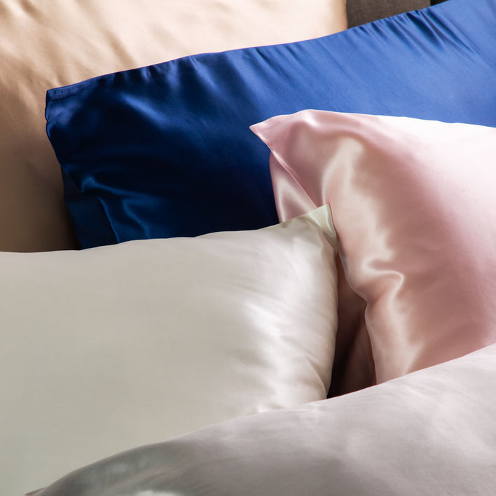 A group of silk, soft pillows in many different colours.