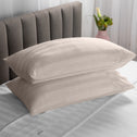 Two soft pillows neatly stacked on top of each other in a blush colour.