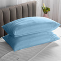 Two soft pillows neatly stacked on top of each other in a light-blue colour.