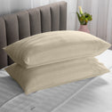 Two soft pillows neatly stacked on top of each other in a warm beige colour.