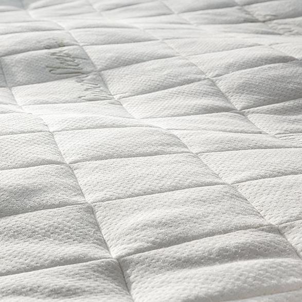 Close-up of the white, textured grid-pattern cover for the Super Sleeper Pro® Wave Topper Replacement Cover, featuring subtle stitching and a soft bamboo viscose surface from Super Sleeper Pro.