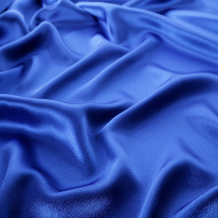 A navy silk pillowcase with a wave effect.